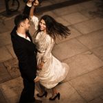 young-elegant-man-holding-hand-whirling-attractive-cheerful-woman