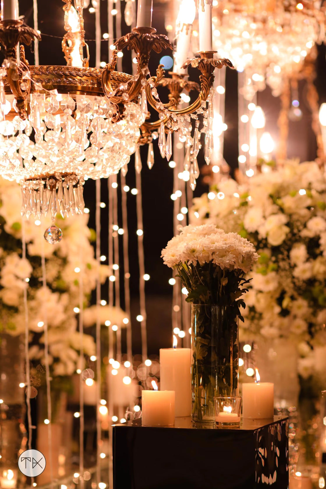 Wedding tablescape with chandeliers and flowers